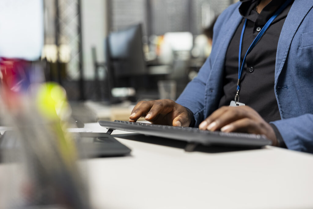 Close up of businessman showcasing a strategic mindset for success, analyzing business data insights with performance metrics. Managing report writing on computer at office workstation.